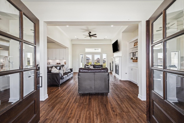 4112 Leslies Way, Dickinson, TX 77539 - living room with dark wood-style flooring, recessed lighting, ceiling fan, a glass covered fireplace, and baseboards