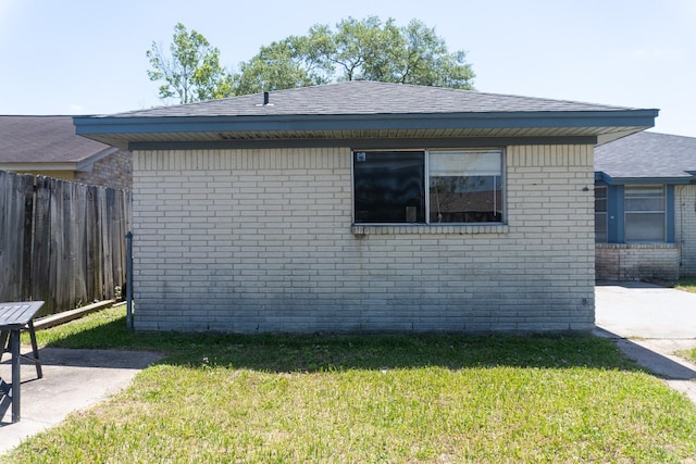702 Meadowglen Dr, Baytown, TX 77521 - view of side of property featuring brick siding, a shingled roof, and a patio