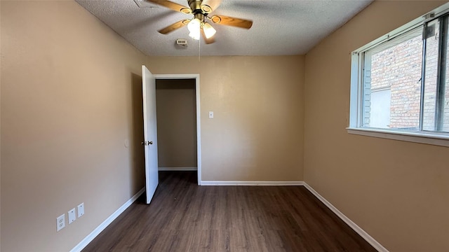 702 Meadowglen Dr, Baytown, TX 77521 - empty room featuring dark wood-style floors, a textured ceiling, and a ceiling fan