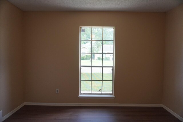 702 Meadowglen Dr, Baytown, TX 77521 - spare room with dark wood-style floors and baseboards