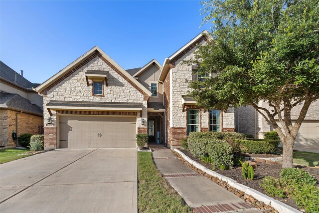3507 Canyon Branch Ln, Fulshear, TX 77441 - view of front facade featuring driveway, an attached garage, brick siding, and stone siding