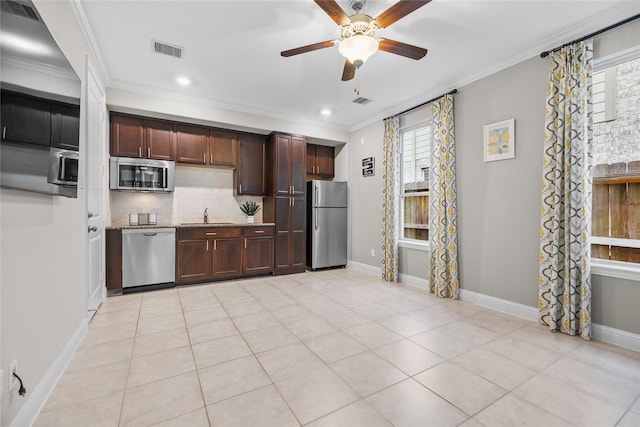 3507 Canyon Branch Ln, Fulshear, TX 77441 - kitchen with appliances with stainless steel finishes, plenty of natural light, a sink, tasteful backsplash, and crown molding