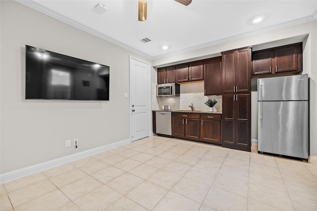 3507 Canyon Branch Ln, Fulshear, TX 77441 - kitchen with stainless steel appliances, a sink, ornamental molding, a ceiling fan, and decorative backsplash