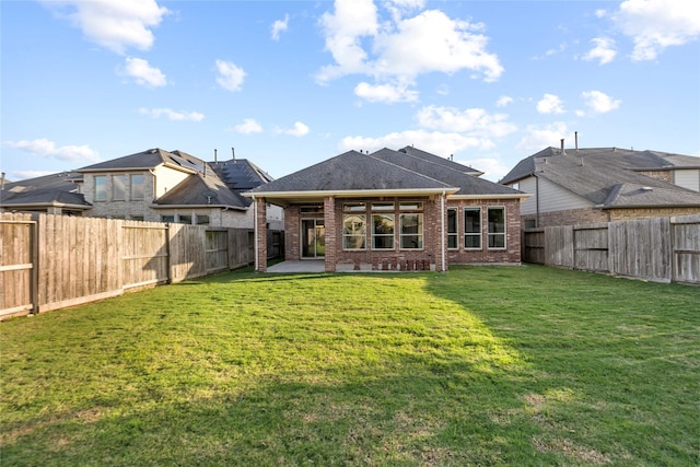 3507 Canyon Branch Ln, Fulshear, TX 77441 - back of house featuring brick siding, a patio area, and roof with shingles