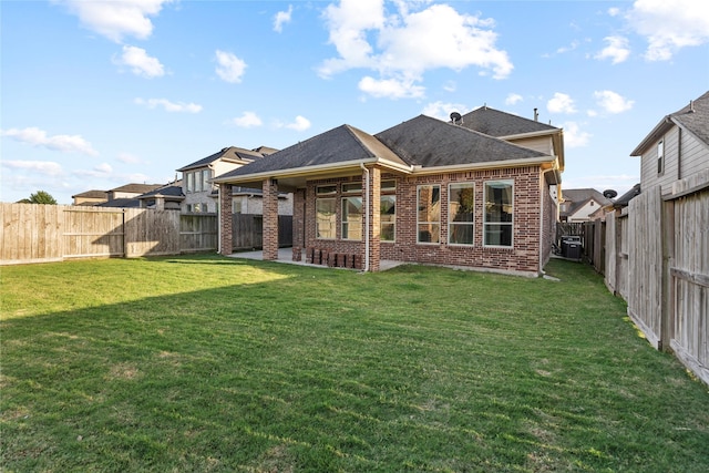 3507 Canyon Branch Ln, Fulshear, TX 77441 - back of property featuring brick siding, a patio area, central AC unit, and roof with shingles