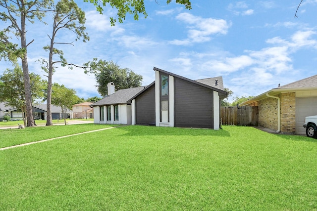 4203 Steep Rock Dr, Pasadena, TX 77504 - view of side of home with an attached garage, a chimney, and a shingled roof