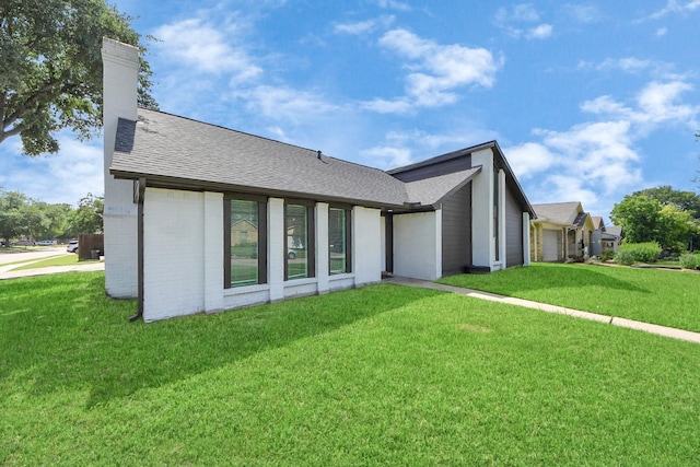 4203 Steep Rock Dr, Pasadena, TX 77504 - view of front of property with a front lawn, a chimney, a shingled roof, and an attached garage