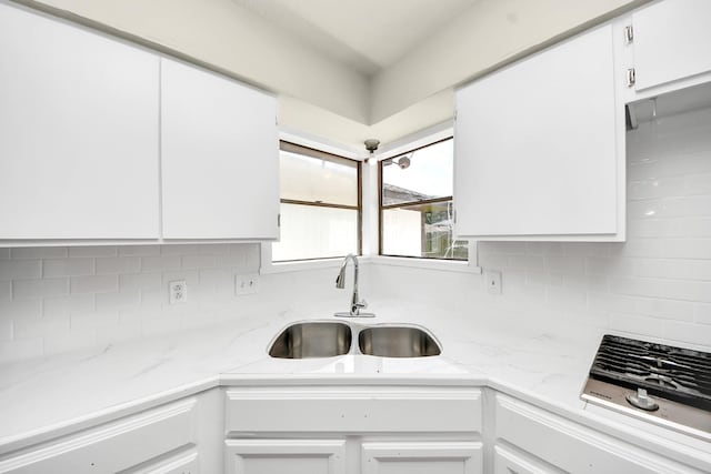 4203 Steep Rock Dr, Pasadena, TX 77504 - kitchen with a sink, white cabinets, backsplash, light stone counters, and stainless steel gas stovetop