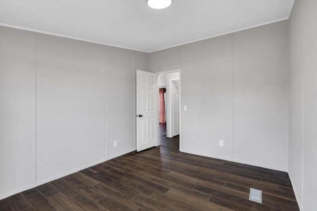 497 Rd 5603, Cleveland, TX 77327 - unfurnished room featuring crown molding and dark wood-style floors