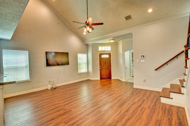 7022 Raven Cliffs Ln, Spring, TX 77379 - entrance foyer featuring ornamental molding, ceiling fan, wood finished floors, arched walkways, and stairs