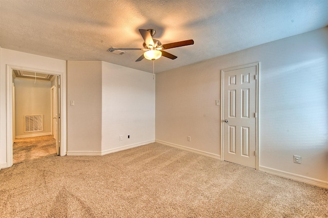 7022 Raven Cliffs Ln, Spring, TX 77379 - unfurnished bedroom with attic access, light carpet, a textured ceiling, and a ceiling fan