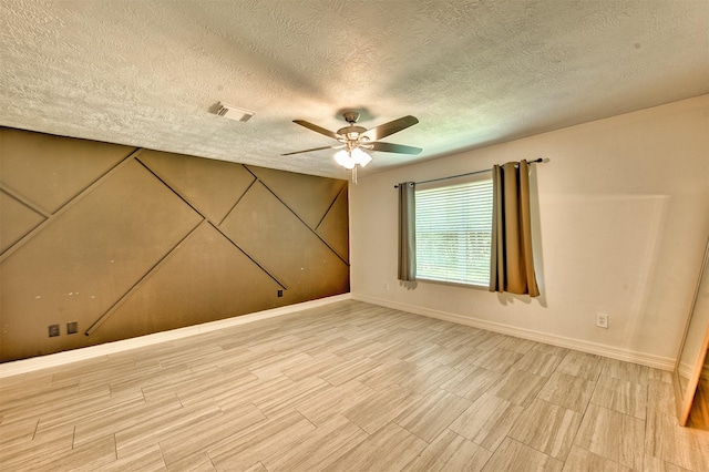 7022 Raven Cliffs Ln, Spring, TX 77379 - unfurnished room with a textured ceiling, a ceiling fan, and light wood-type flooring