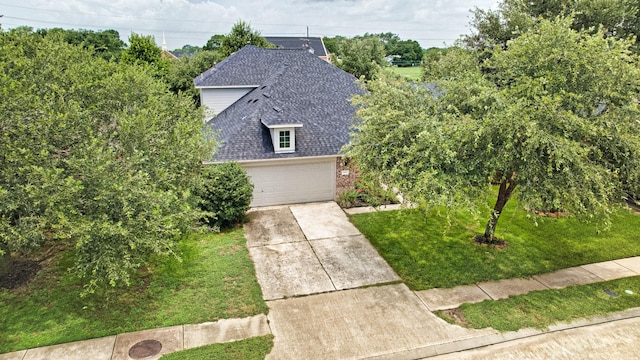 7022 Raven Cliffs Ln, Spring, TX 77379 - view of front of home with roof with shingles, a garage, a front yard, and driveway