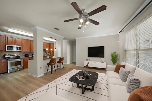 1711 Old Spanish Trl Unit 218, Houston, TX 77054 - living area with ornamental molding, light wood finished floors, a ceiling fan, and baseboards