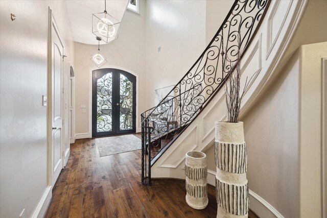 3822 Drummond St, Houston, TX 77025 - foyer with french doors, arched walkways, dark wood-type flooring, stairway, and a high ceiling