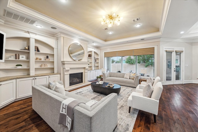 3822 Drummond St, Houston, TX 77025 - living area featuring crown molding, a chandelier, dark wood-style flooring, a glass covered fireplace, and a tray ceiling