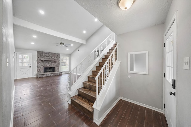 2251 Middle Creek Dr, Houston, TX 77339 - stairs with baseboards, wood finished floors, a ceiling fan, a fireplace, and a textured ceiling