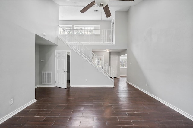2251 Middle Creek Dr, Houston, TX 77339 - unfurnished living room with a high ceiling, stairway, a ceiling fan, wood finish floors, and healthy amount of natural light