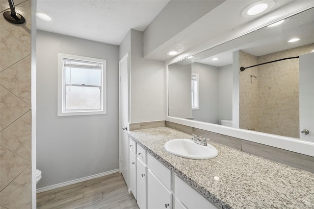 2251 Middle Creek Dr, Houston, TX 77339 - bathroom featuring toilet, wood finished floors, vanity, healthy amount of natural light, and recessed lighting