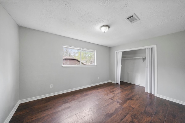 2251 Middle Creek Dr, Houston, TX 77339 - unfurnished bedroom featuring wood finished floors, baseboards, a closet, and a textured ceiling