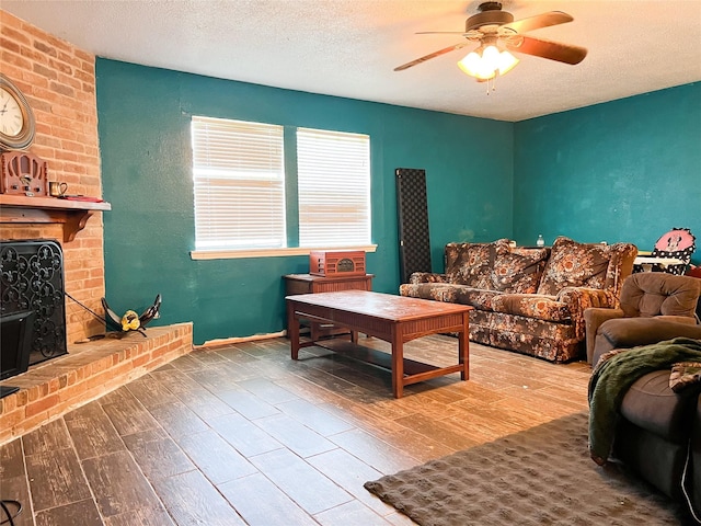 2406 W US Highway 79, Buffalo, TX 75831 - living area with wood finished floors, a ceiling fan, a brick fireplace, a textured ceiling, and baseboards
