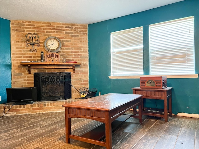 2406 W US Highway 79, Buffalo, TX 75831 - living area with wood-type flooring, a brick fireplace, and baseboards
