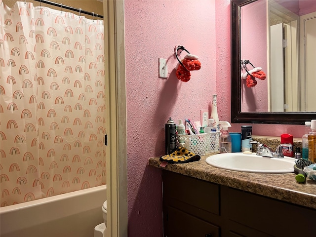 2406 W US Highway 79, Buffalo, TX 75831 - full bathroom with a textured wall, vanity, toilet, and shower / bath combo