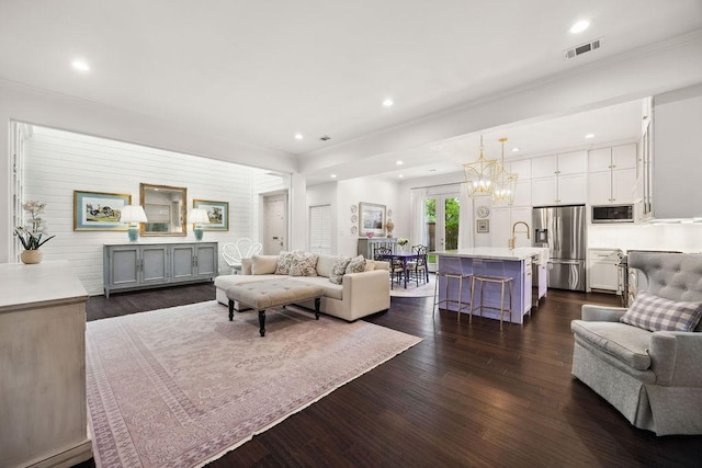 6000 Sugar Hill Dr Unit 1, Houston, TX 77057 - living area featuring dark wood-type flooring, ornamental molding, recessed lighting, and a chandelier