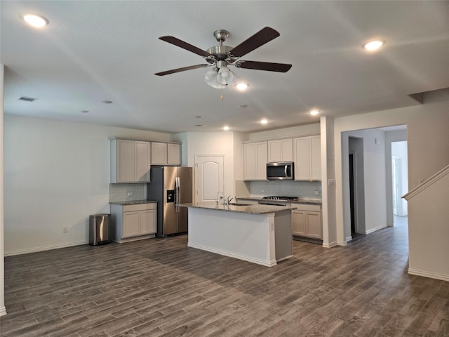 7927 Chukka Dr, Fulshear, TX 77441 - kitchen with stainless steel appliances, dark wood-type flooring, decorative backsplash, a ceiling fan, and recessed lighting