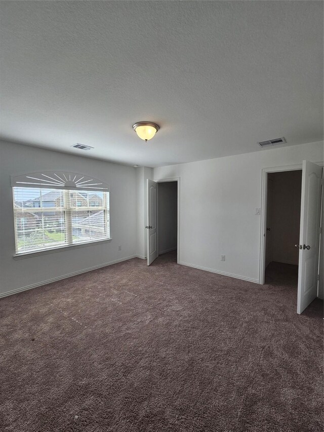 7927 Chukka Dr, Fulshear, TX 77441 - unfurnished bedroom with carpet floors and a textured ceiling
