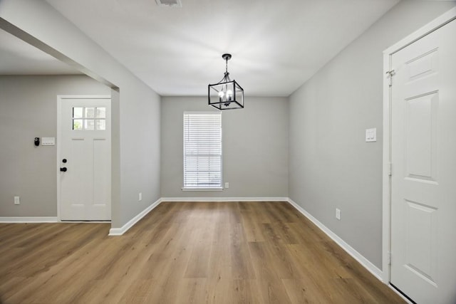 4442 Oak Shadows Dr, Houston, TX 77091 - entrance foyer with light wood-style floors, a chandelier, and baseboards
