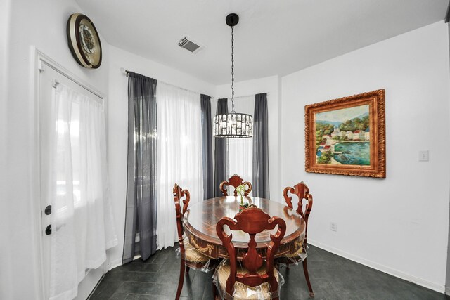 7410 Lassiter Hollow Ln, Richmond, TX 77407 - dining space featuring a chandelier and baseboards