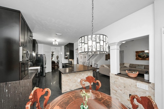 7410 Lassiter Hollow Ln, Richmond, TX 77407 - dining space with stairway, decorative columns, and a chandelier