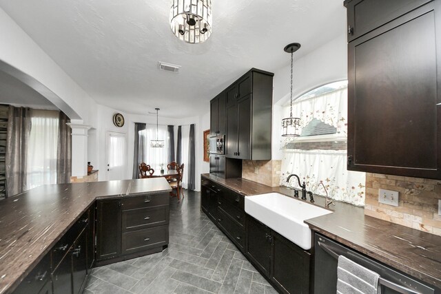 7410 Lassiter Hollow Ln, Richmond, TX 77407 - kitchen featuring stainless steel microwave, backsplash, plenty of natural light, and dark countertops