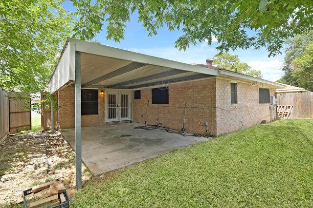 1318 Epsilon St, Pasadena, TX 77504 - back of property with french doors, brick siding, and a patio