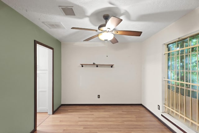 1318 Epsilon St, Pasadena, TX 77504 - spare room featuring light wood finished floors, ceiling fan, a textured ceiling, and baseboards