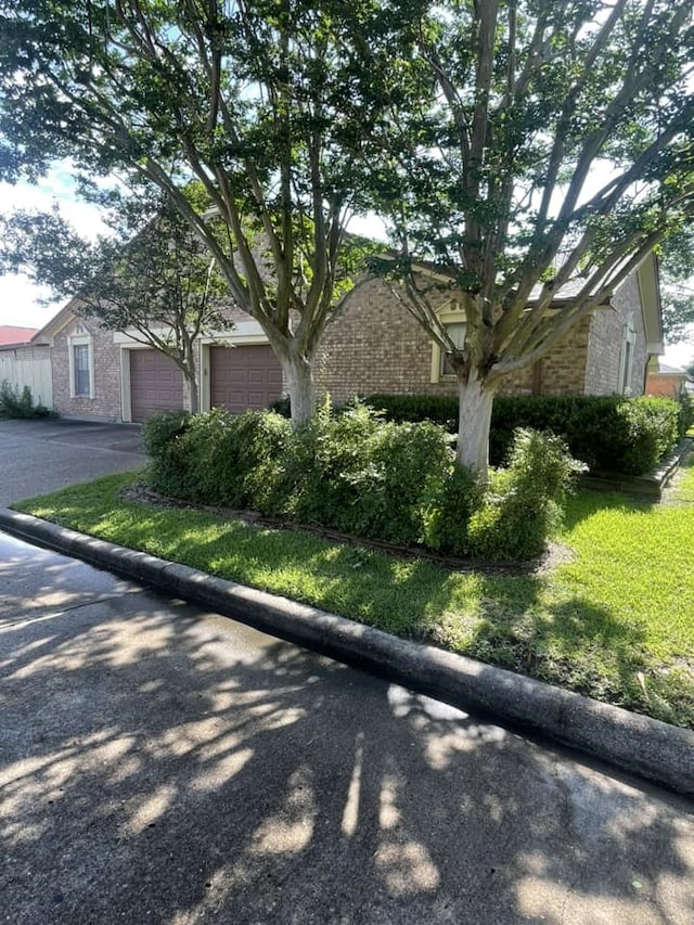 2724 22nd Ave N, Texas City, TX 77590 - view of front of property with brick siding, driveway, and a garage