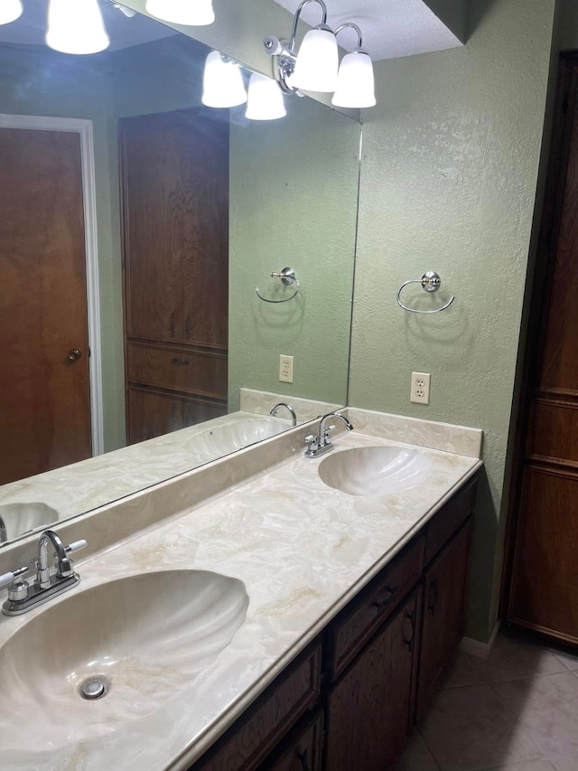 2724 22nd Ave N, Texas City, TX 77590 - bathroom featuring tile patterned floors, double vanity, and a textured wall