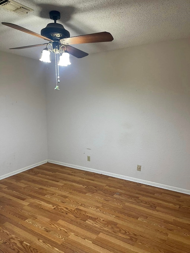 2724 22nd Ave N, Texas City, TX 77590 - spare room with ceiling fan, wood finished floors, baseboards, and a textured ceiling