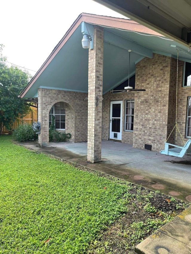 2724 22nd Ave N, Texas City, TX 77590 - rear view of property featuring a patio, a lawn, and brick siding