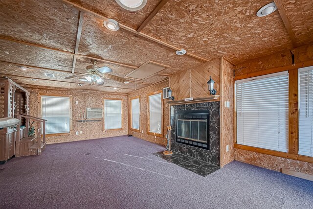 7650 Smiling Wood Ln, Houston, TX 77086 - unfurnished living room featuring a ceiling fan, carpet, an AC wall unit, a fireplace, and attic access