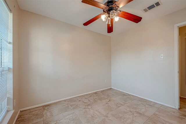 7650 Smiling Wood Ln, Houston, TX 77086 - empty room with baseboards, light marble finish flooring, and ceiling fan