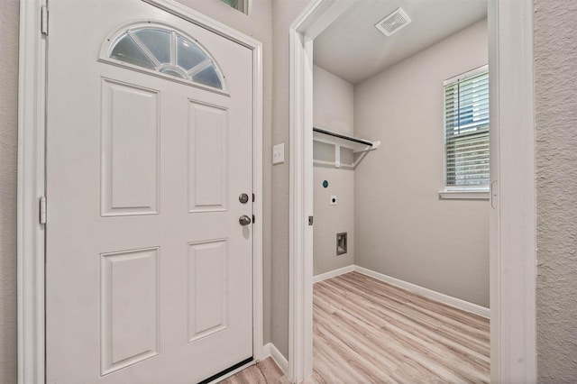 24708 Sonora Crescent Cir, Huffman, TX 77336 - laundry area featuring light wood-style floors, baseboards, and hookup for an electric dryer