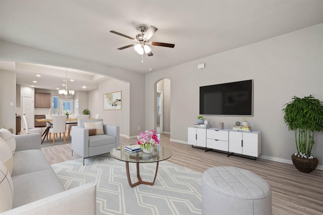 24708 Sonora Crescent Cir, Huffman, TX 77336 - living area featuring arched walkways, light wood-style floors, a ceiling fan, baseboards, and recessed lighting