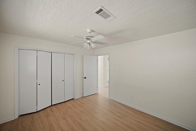 13510 Cedar Point Dr, Cypress, TX 77429 - unfurnished bedroom featuring light wood-type flooring, a textured ceiling, baseboards, a closet, and a ceiling fan