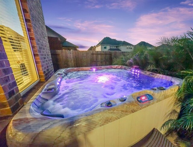 20714 Fertile Valley Ln, Richmond, TX 77407 - pool at dusk with a hot tub