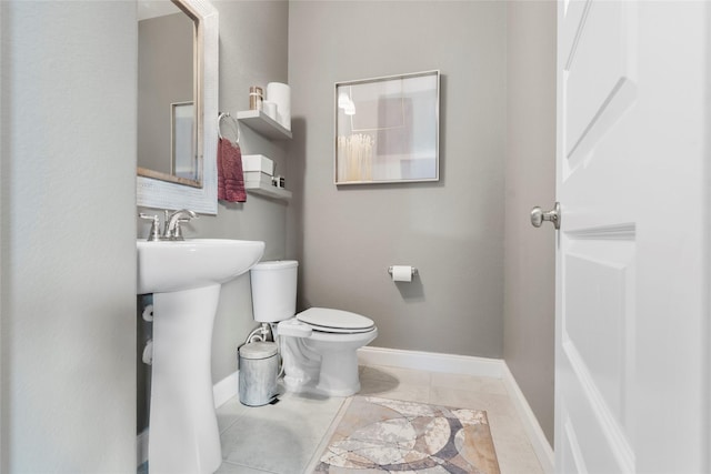 20714 Fertile Valley Ln, Richmond, TX 77407 - bathroom with baseboards, toilet, and a sink