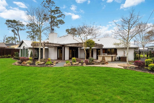 4031 Fernwood Dr, Houston, TX 77021 - back of house featuring a pergola, a patio area, a chimney, and a metal roof