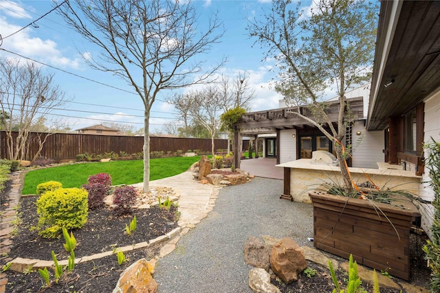 4031 Fernwood Dr, Houston, TX 77021 - fenced backyard featuring area for grilling, a pergola, and a patio