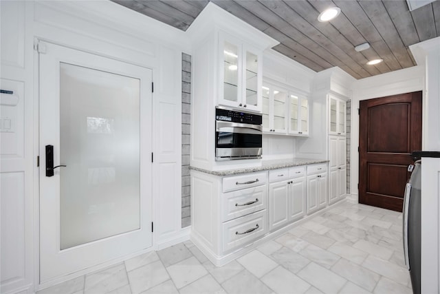 4031 Fernwood Dr, Houston, TX 77021 - kitchen featuring wood ceiling, white cabinets, light stone counters, glass insert cabinets, and recessed lighting